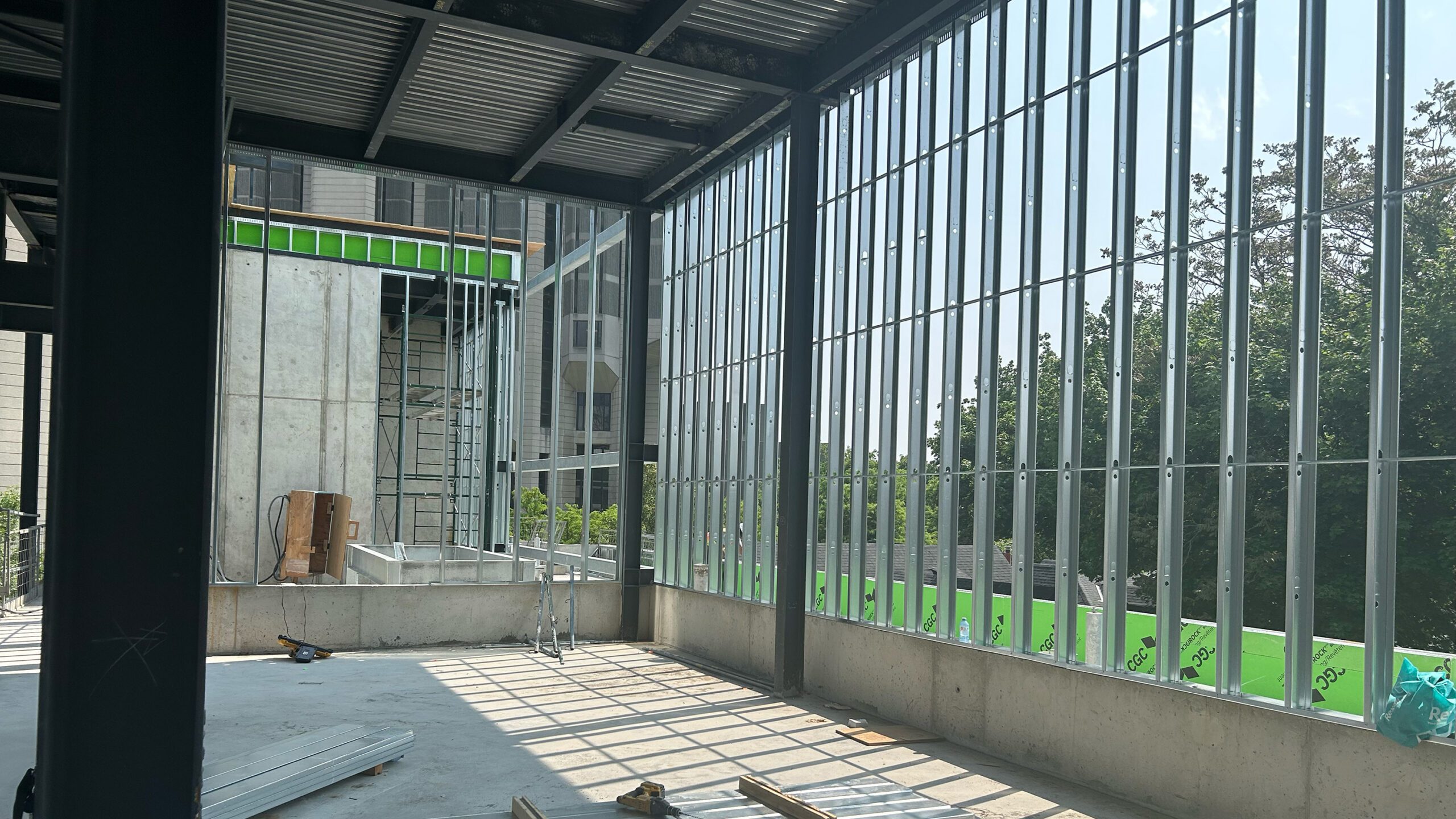 Construction photo showing exterior wall framing installed on fourth level