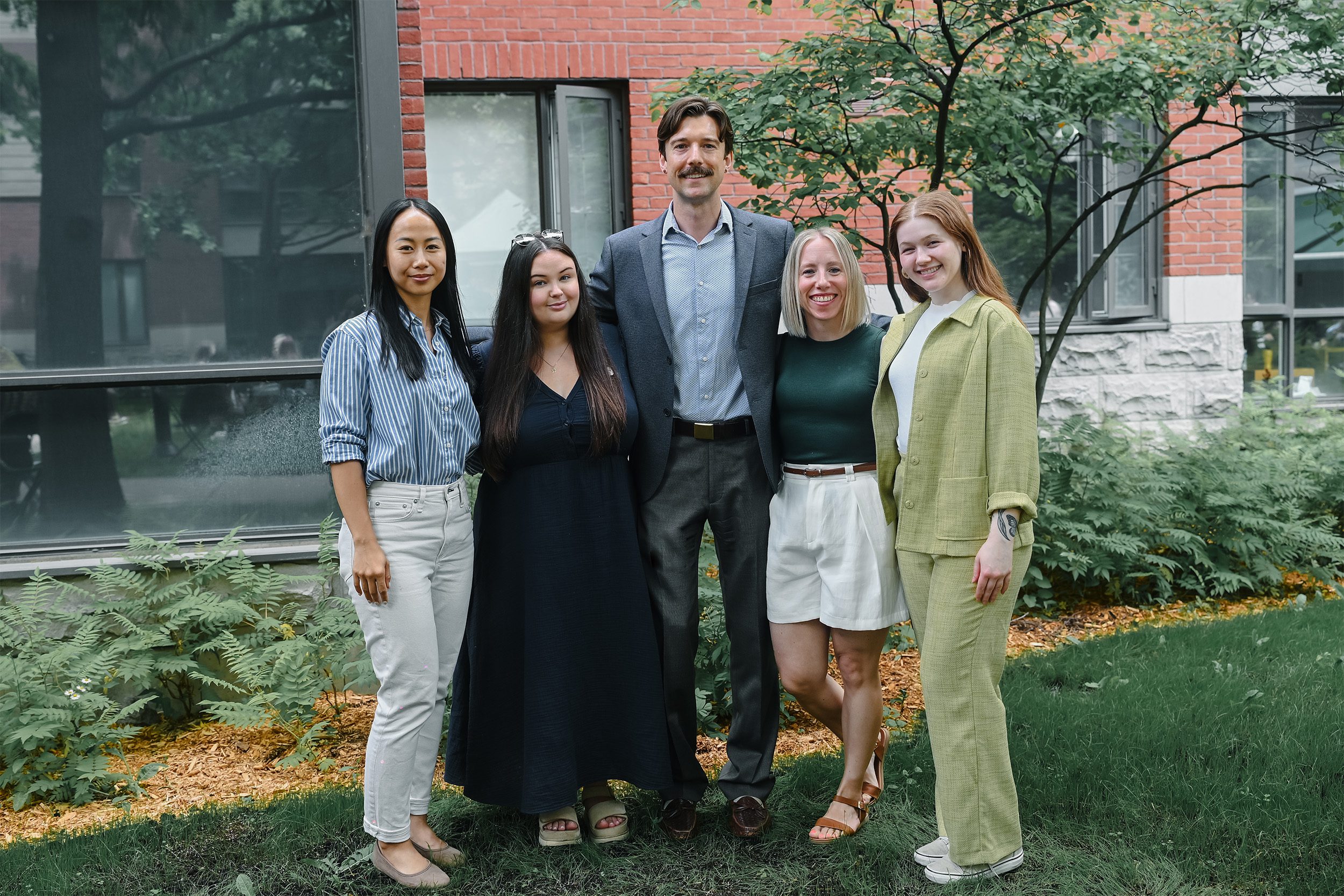 five members of the Alumni Office pose outside of Innis Residence